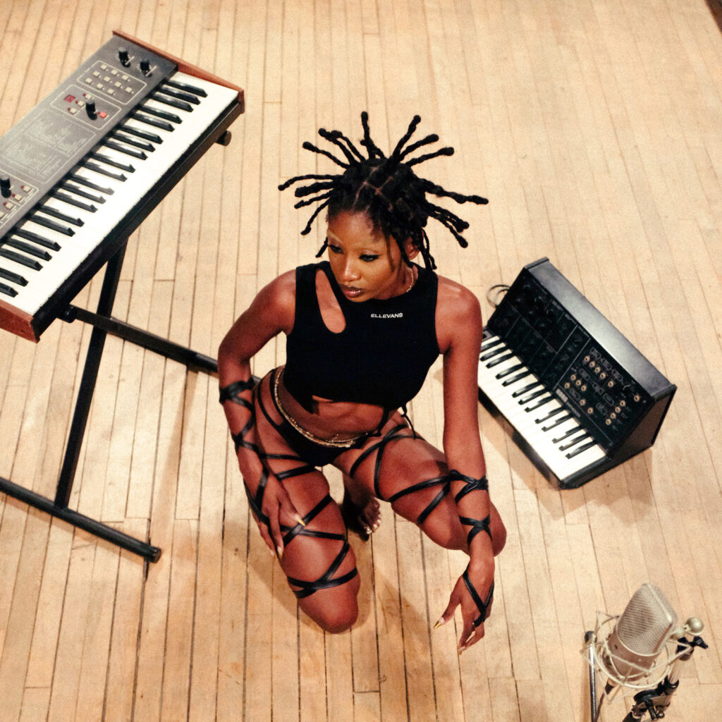 hero image model wearing black asymmetrical tank top